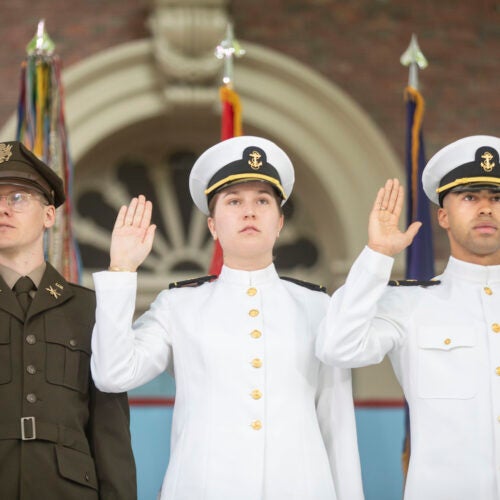 Aaron Boehm, GSAS, (from left) Elisabeth Aigeldinger, Isaiah Coleman, Navy take their oath.