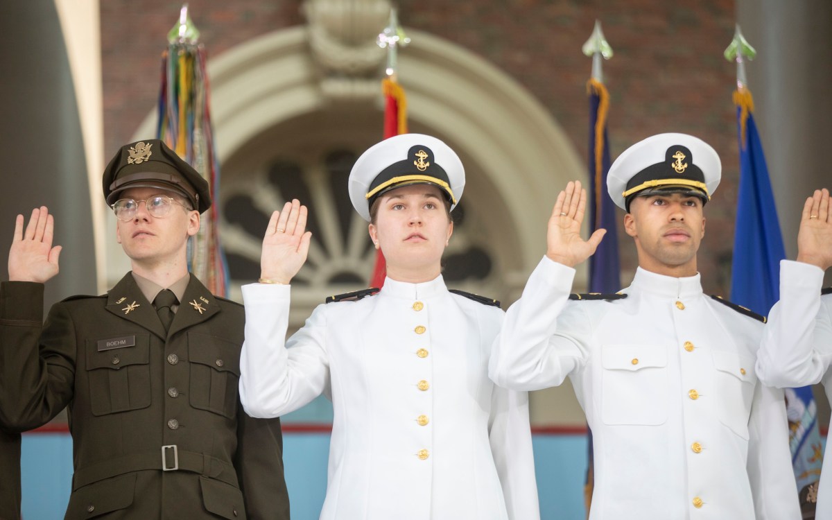 Aaron Boehm, GSAS, (from left) Elisabeth Aigeldinger, Isaiah Coleman, Navy take their oath.