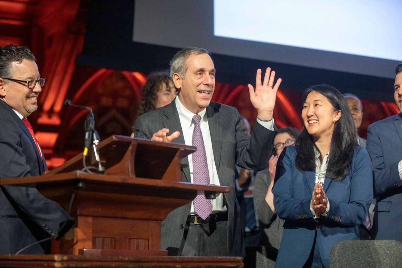 Larry Bacow waves as he receives Harvard Heroes award.