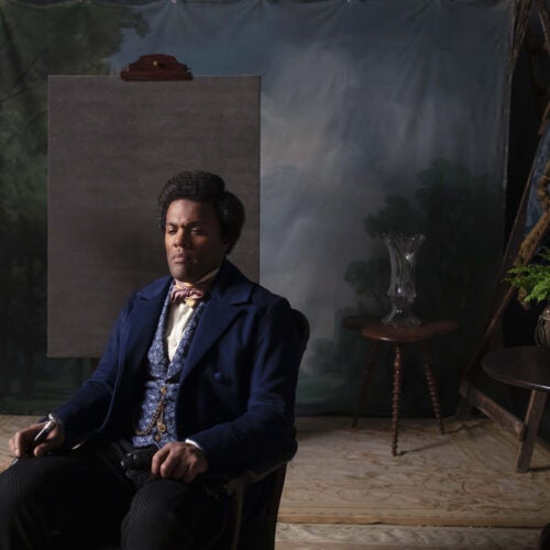 Frederick Douglass sits in photo studio chair in Isaac Julien's "Lessons of the Hour."