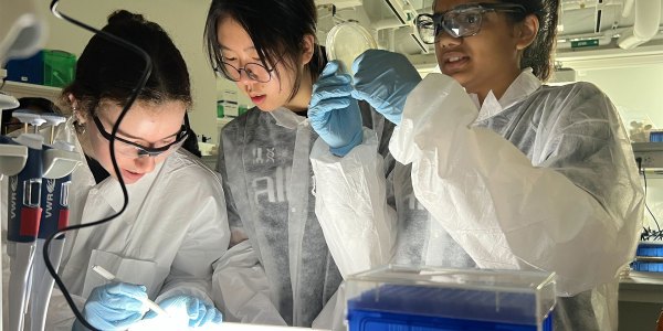 Three students in a lab.