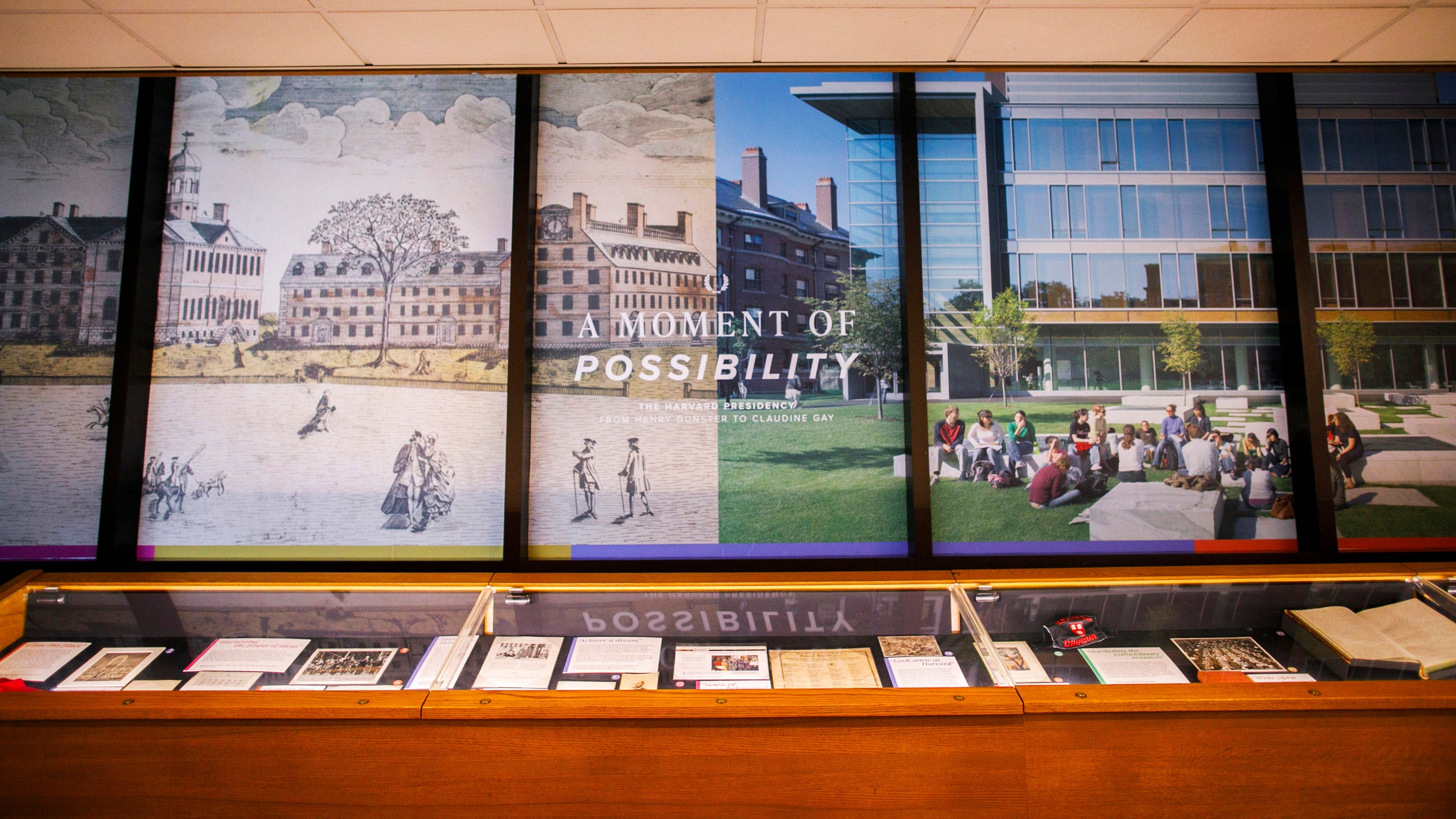 Main wall and glass case of an exhibition of historical items related to Harvard's presidency.