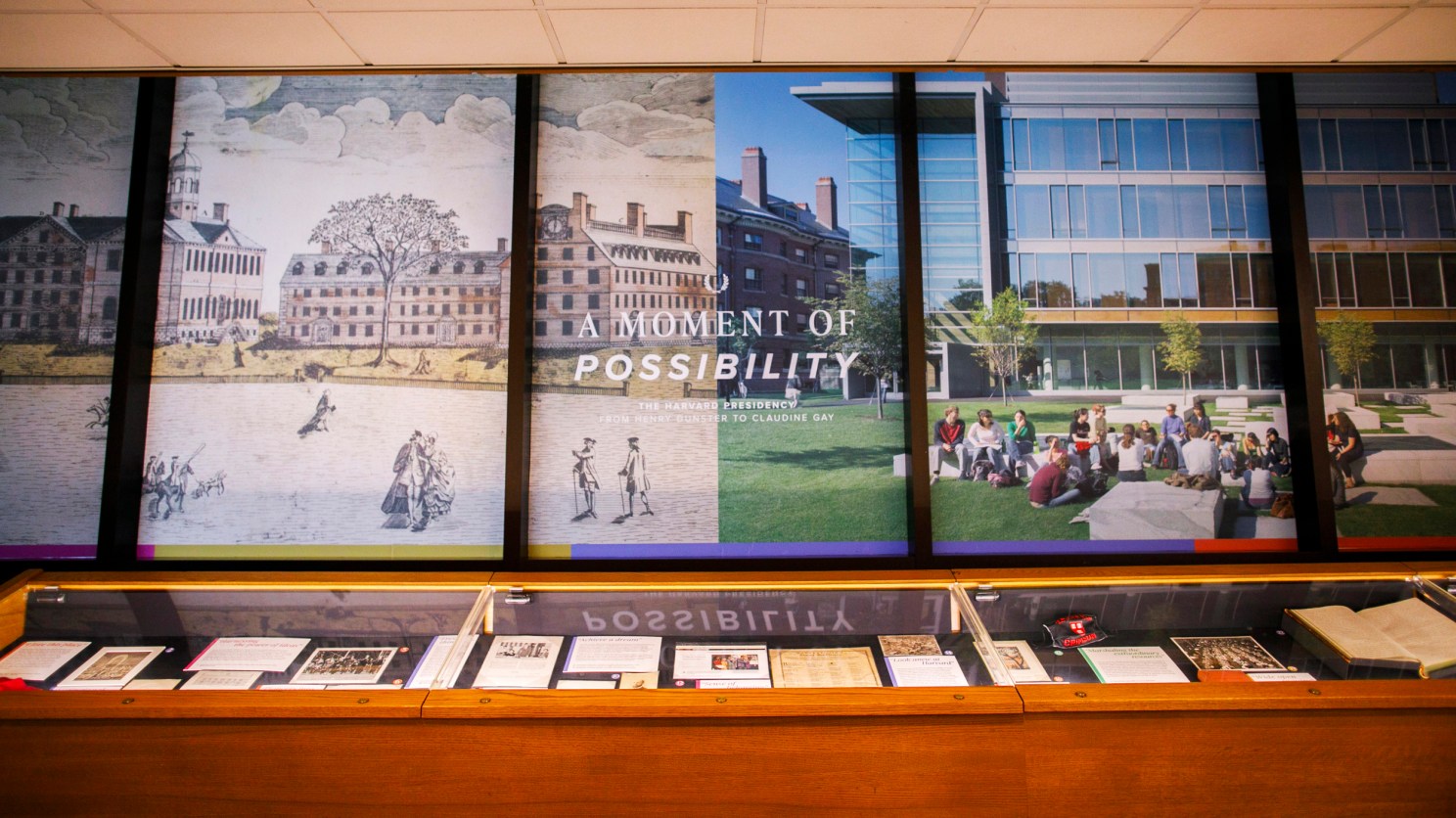 Main wall and glass case of an exhibition of historical items related to Harvard's presidency.