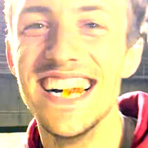 Will Sorenson clenches gummy bear he caught in his mouth between his teeth.