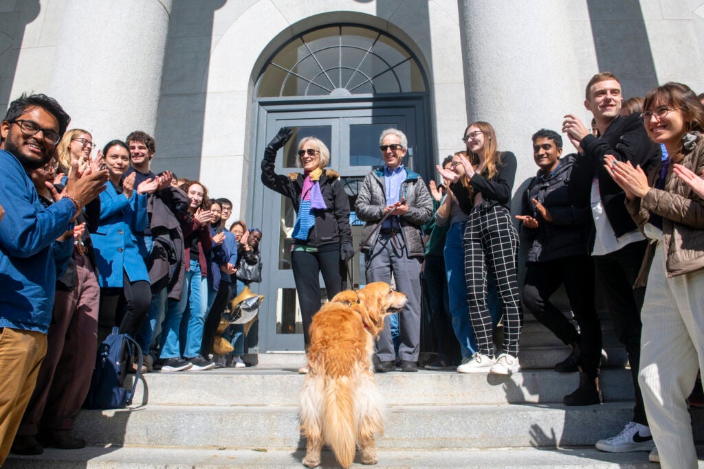 Claudia Goldin and Lawrence Katz with their dog on the steps of Littauer.