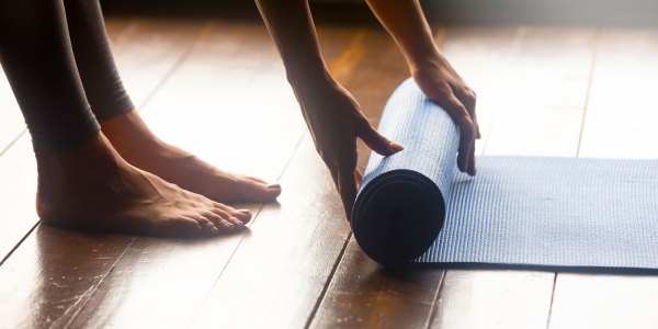 Woman unrolling mat.