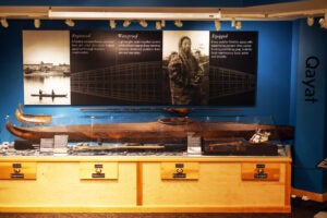 Historic kayak in glass case in Alutiiq Museum.