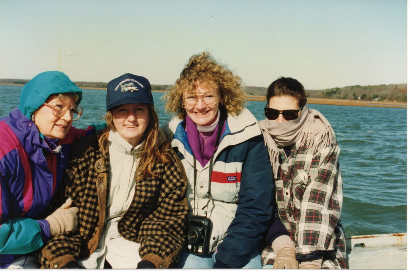 Barbara Collins, Bobbie Collins, Chrissy Dobbyn Wood, and Susan Kropp Collines pose for a photo by the water in the early 1990s.
