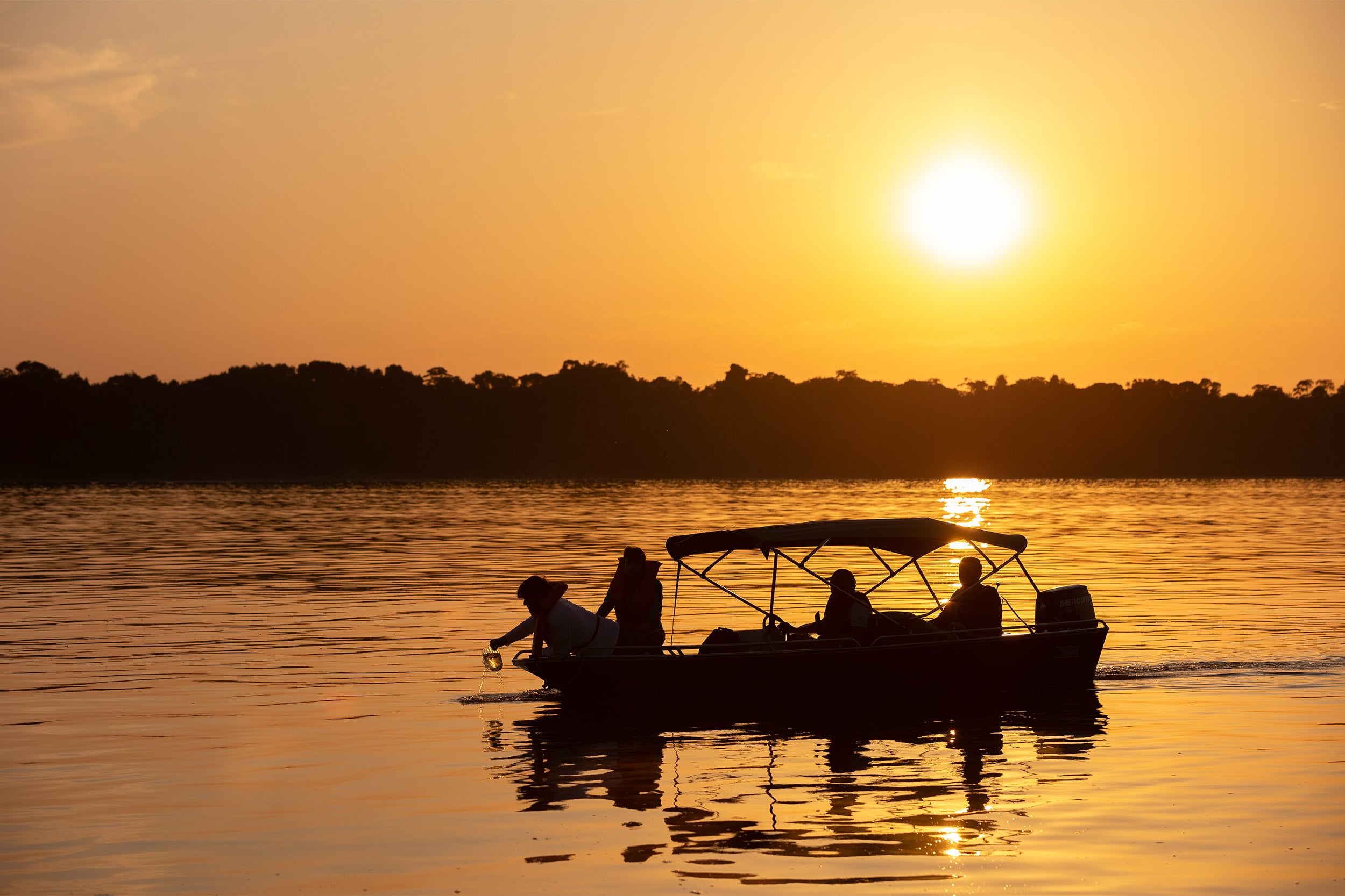 Researchers during water collection at dawn on the Rio Negro.