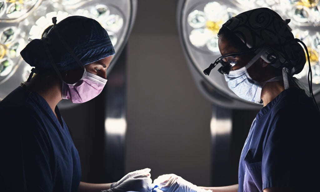 Nurse Practitioner Madeline Macaluso, and Facial Plastic Surgeon Linda Lee, MD, working in synchrony in the operating room.