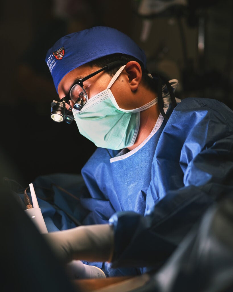 Dr. Hoang Nguyen harvesting a muscle in the leg, which will be transferred into the face to aid in the facial reanimation of a patient with facial paralysis.