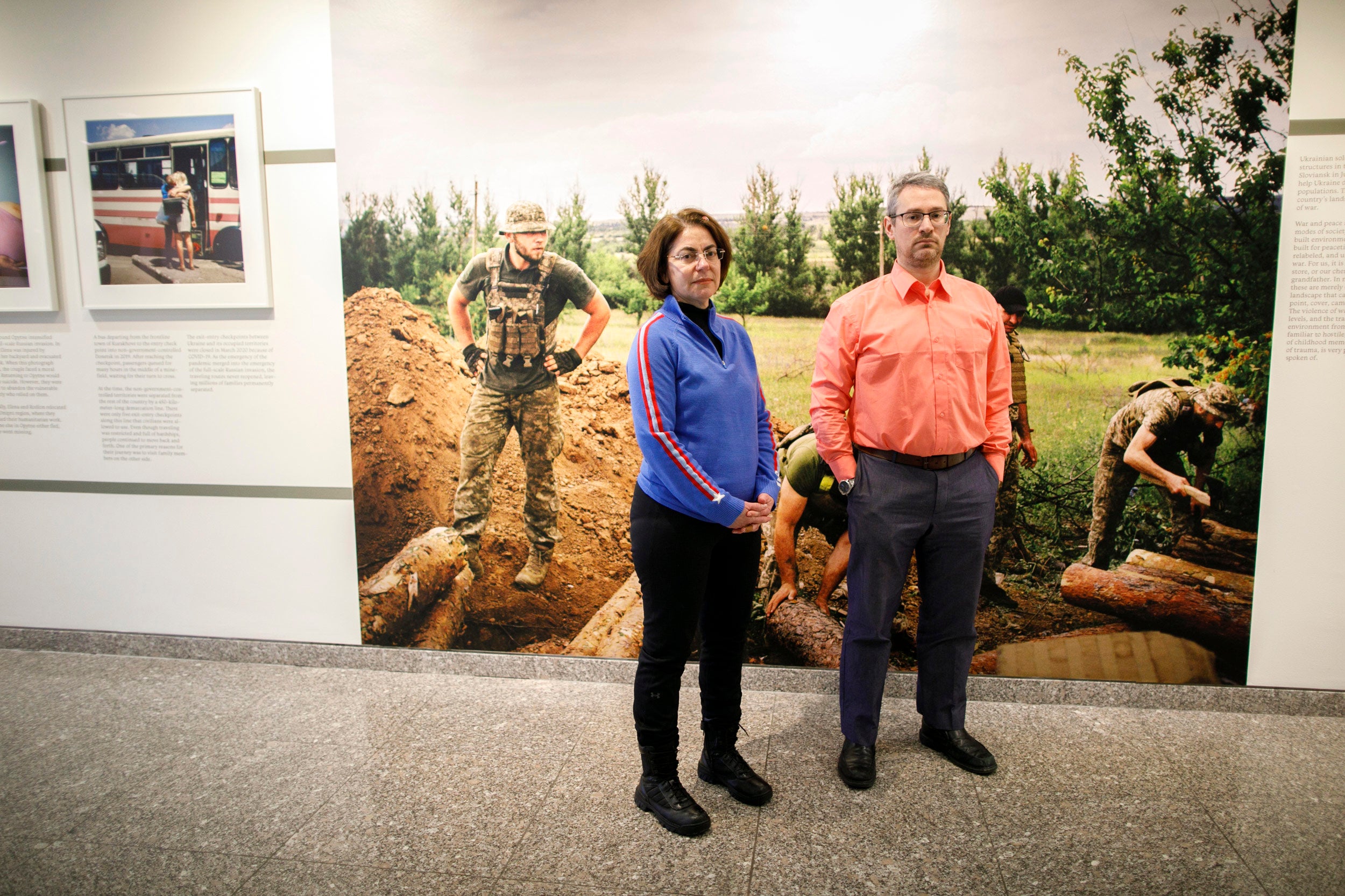 Alexandra Vacroux and Daniel Epsteinstanding in an exhibition called “5K from the Frontline” that features photography by Anastasia Taylor-Lind taken in the region of Donbas of eastern Ukraine.