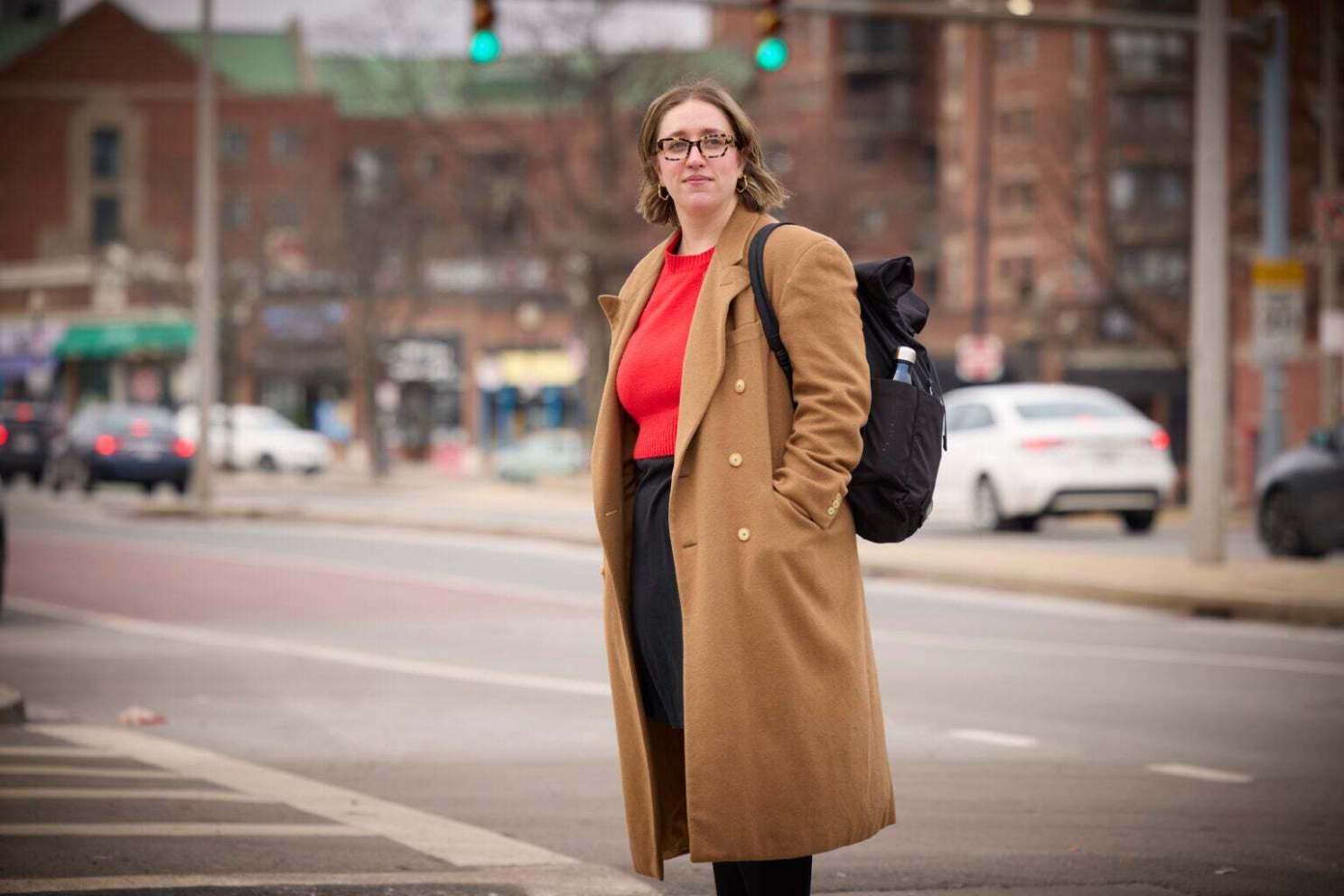 Jen Cruz standing with her backpack on the street. 