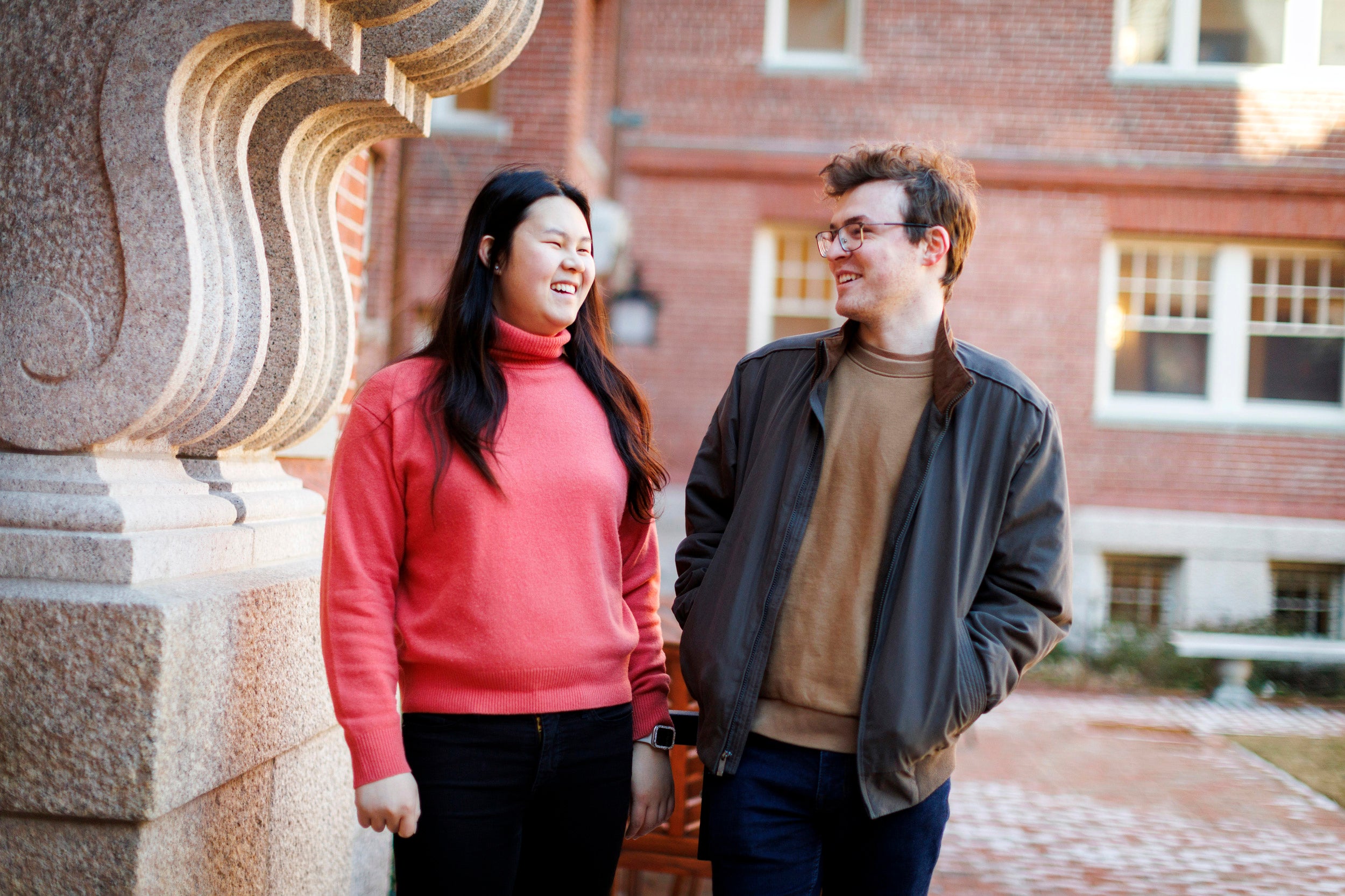 Lily Liu (left) and Tate Underwood share a moment in the Randolph Courtyard, one of their favorite locations at Adams House.