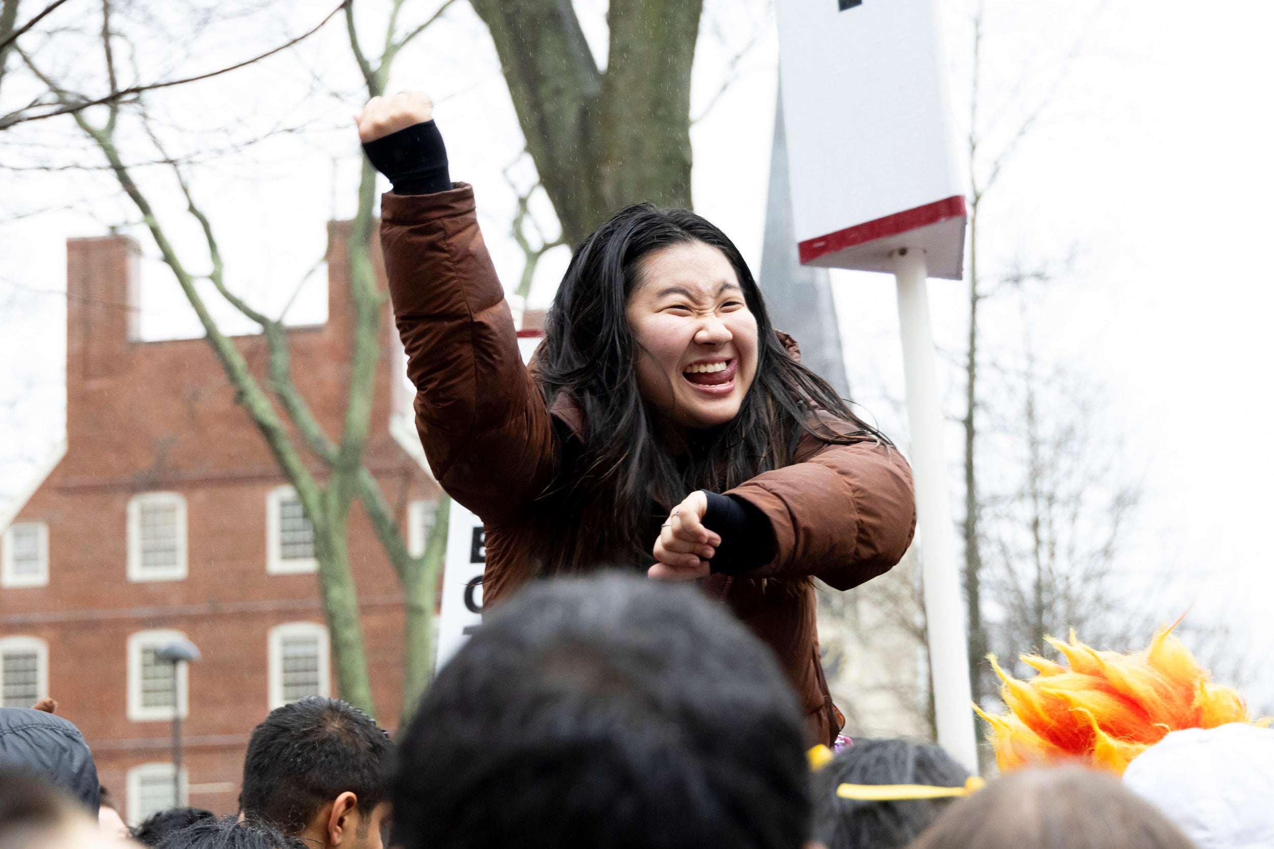 A student cheers for Cabot House in Harvard Yard.