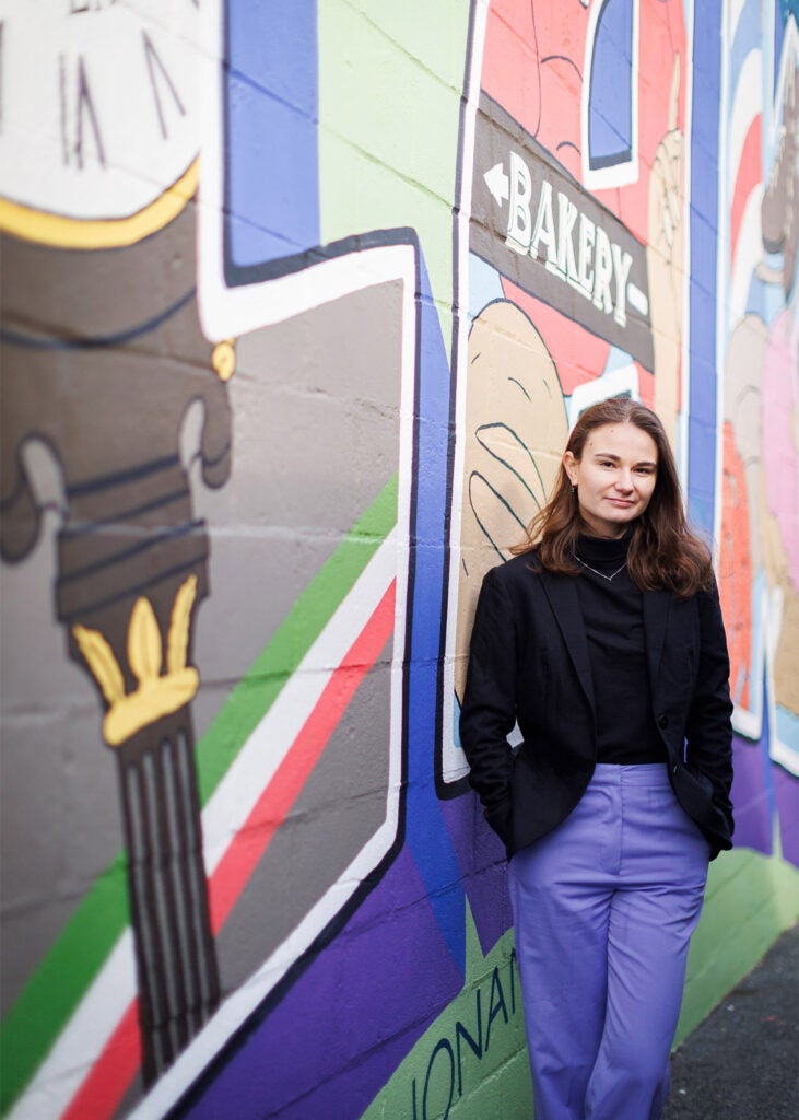 Madeline Ranalli is pictured alongside a mural promoting Nonantum, one of 13 villages within her hometown of Newton, Massachusetts.