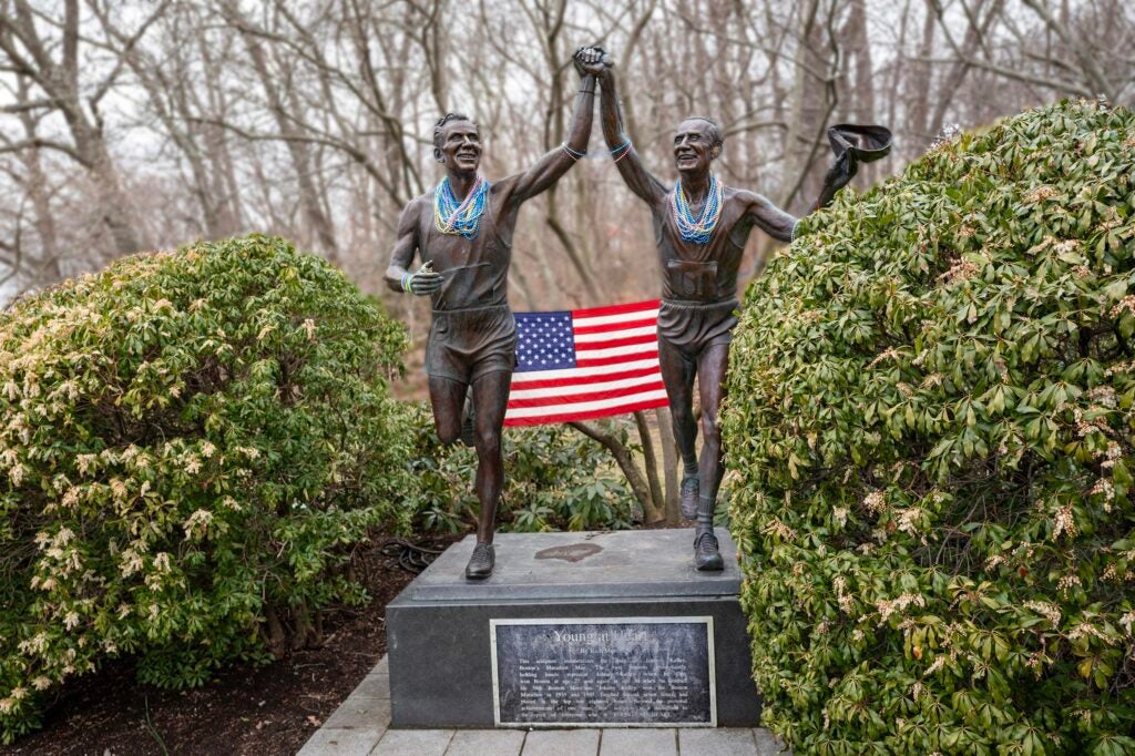 Statue of Johnny Kelley that depicts two versions of Kelley, one at age 27 after his first Boston win, holding hands with his older self, after running the last of his 58 Boston Marathons at age 84.