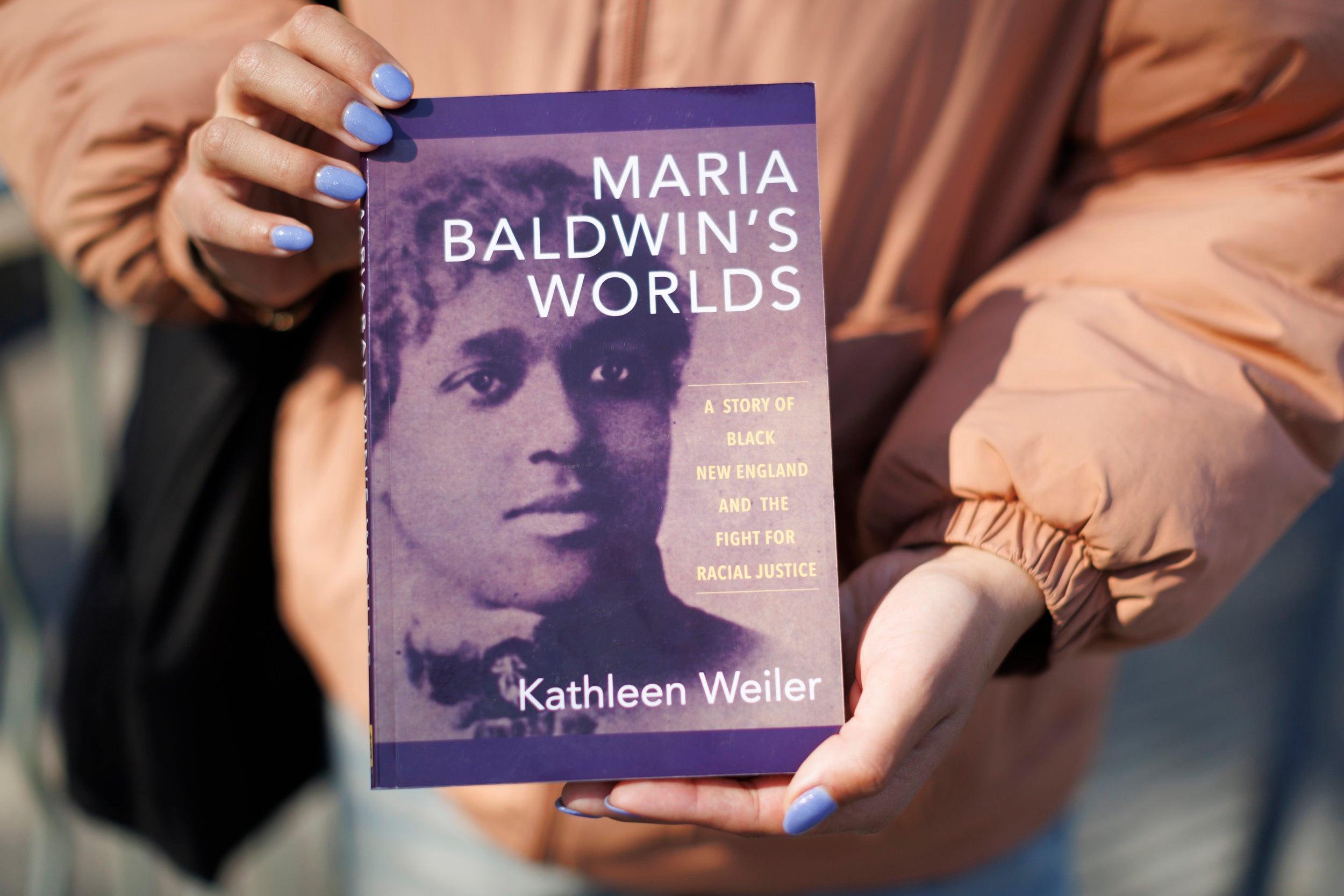 Maya Counter holds a book about Maria Baldwin.