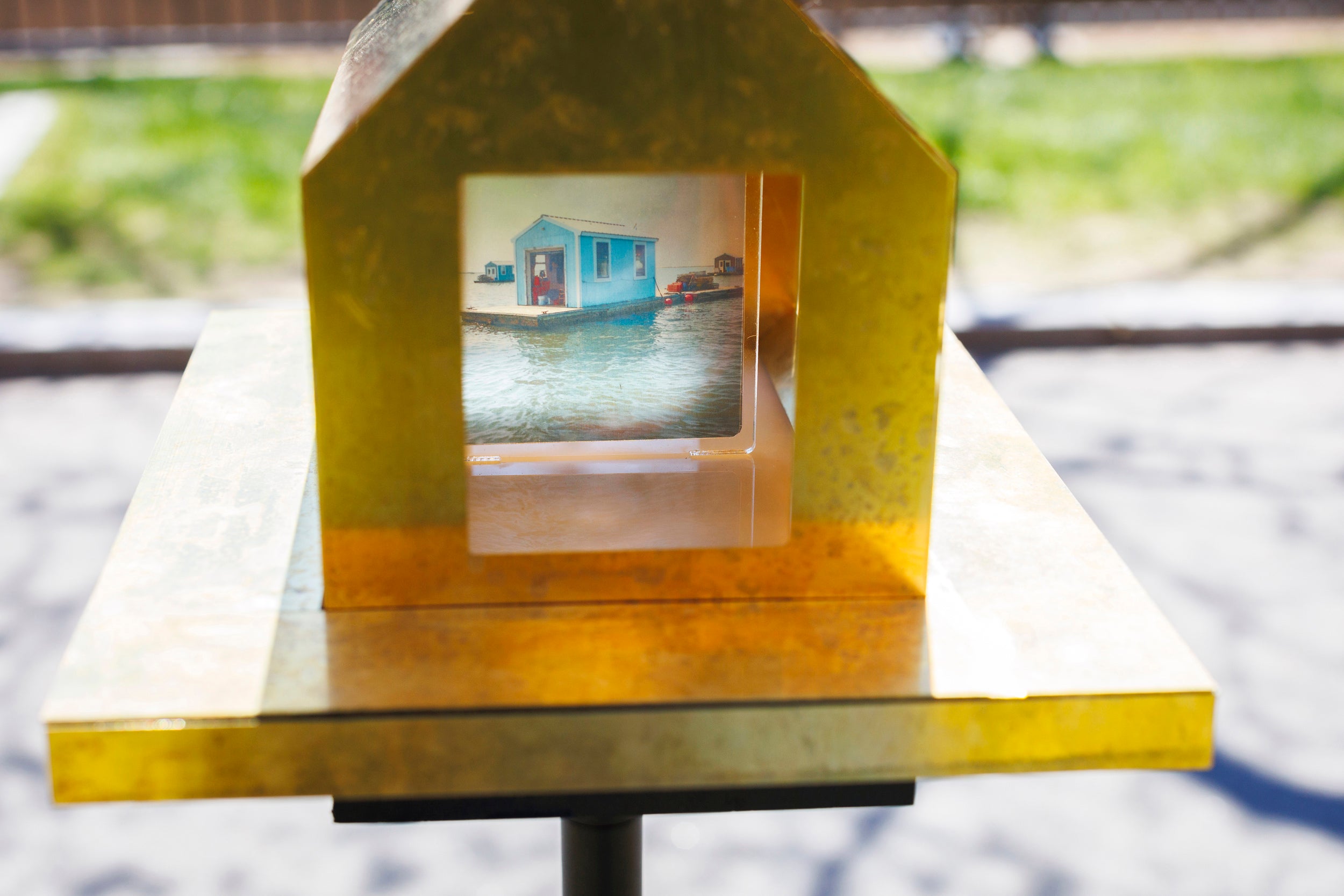 A detail image of a public art installation called “Oyster Floats, Camera Obscuras for a Floating City” by Randy Crandon GSD ’25 and Dylan Herrmann-Holt GSD ’25 is pictured alongside Memorial Hall.