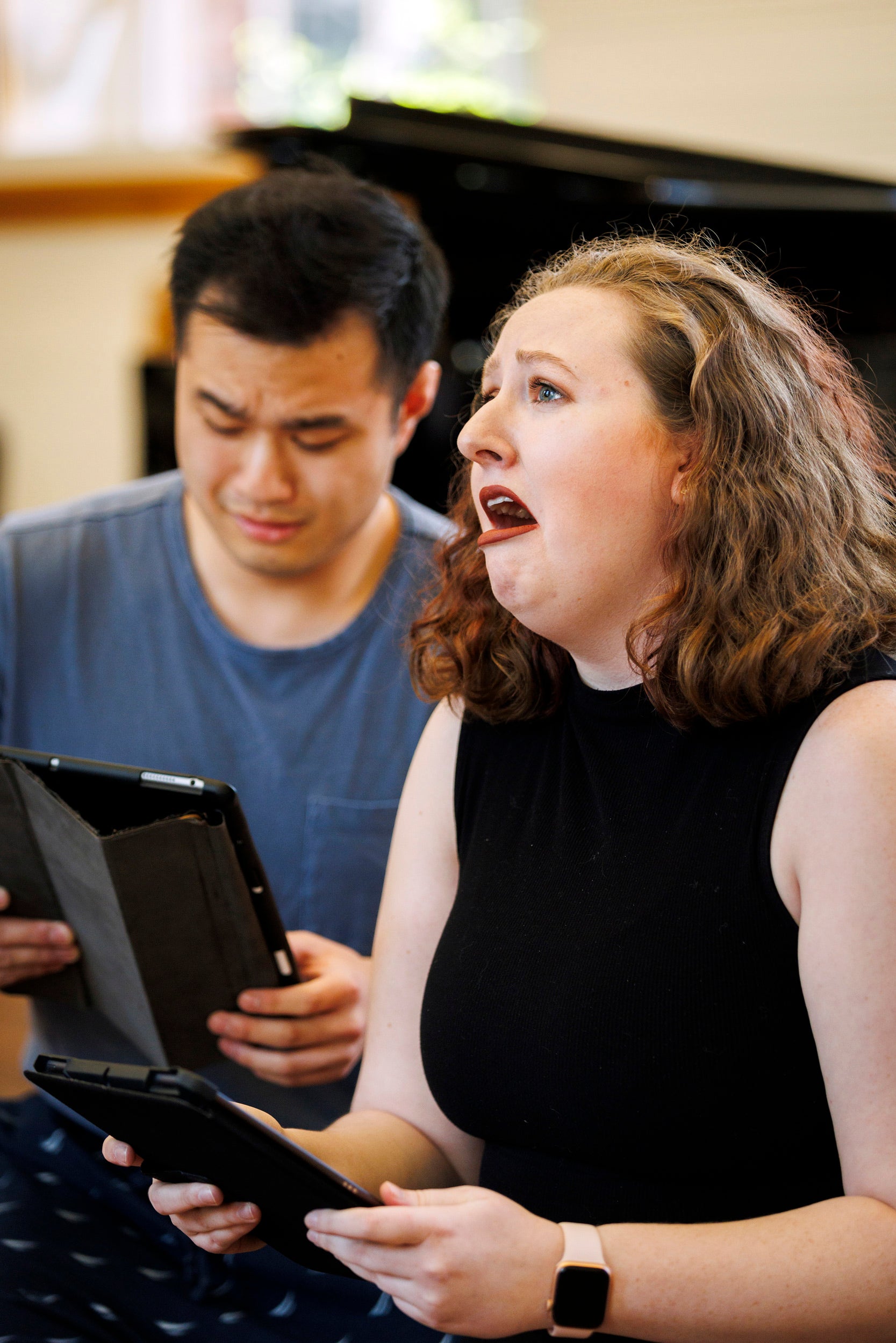 Andrew Lu ’24 (left) and Caitlin Paul ‘24 sing during a performance.