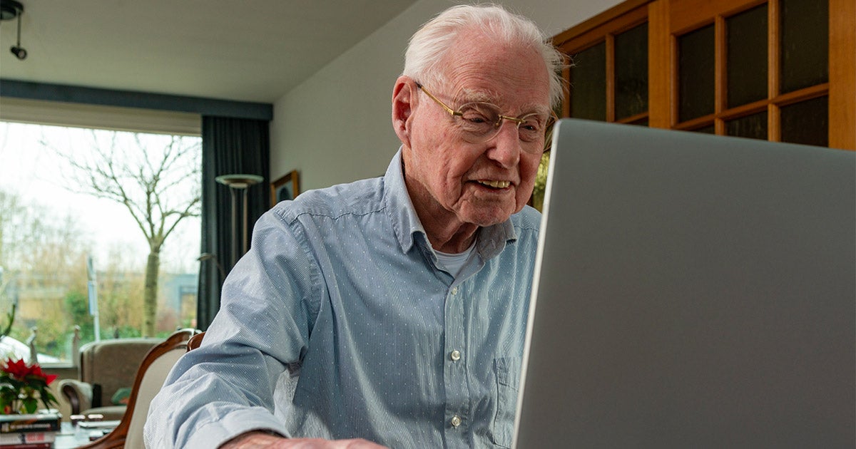 Elderly man with computer.