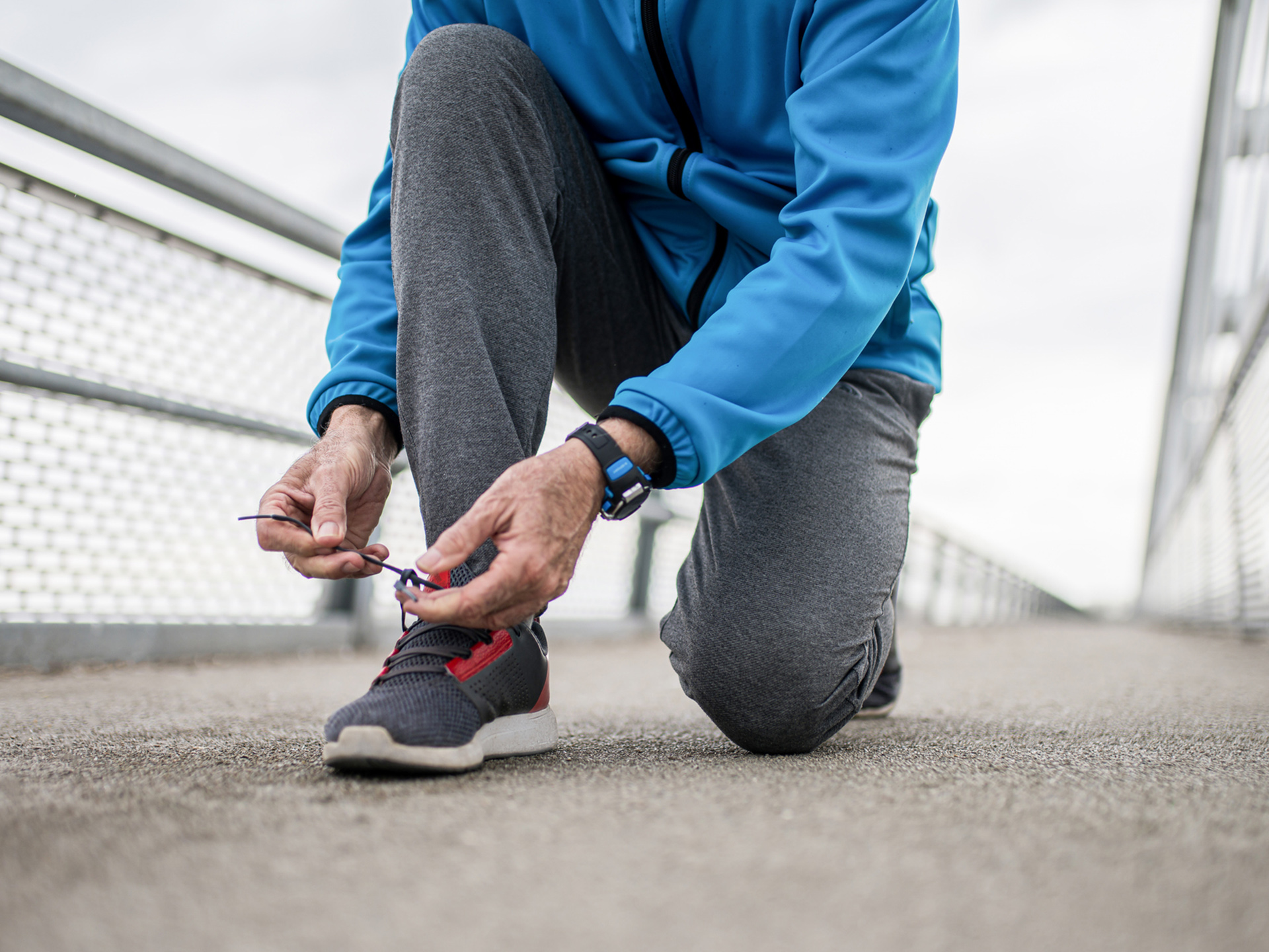 Runner lacing up sneakers.