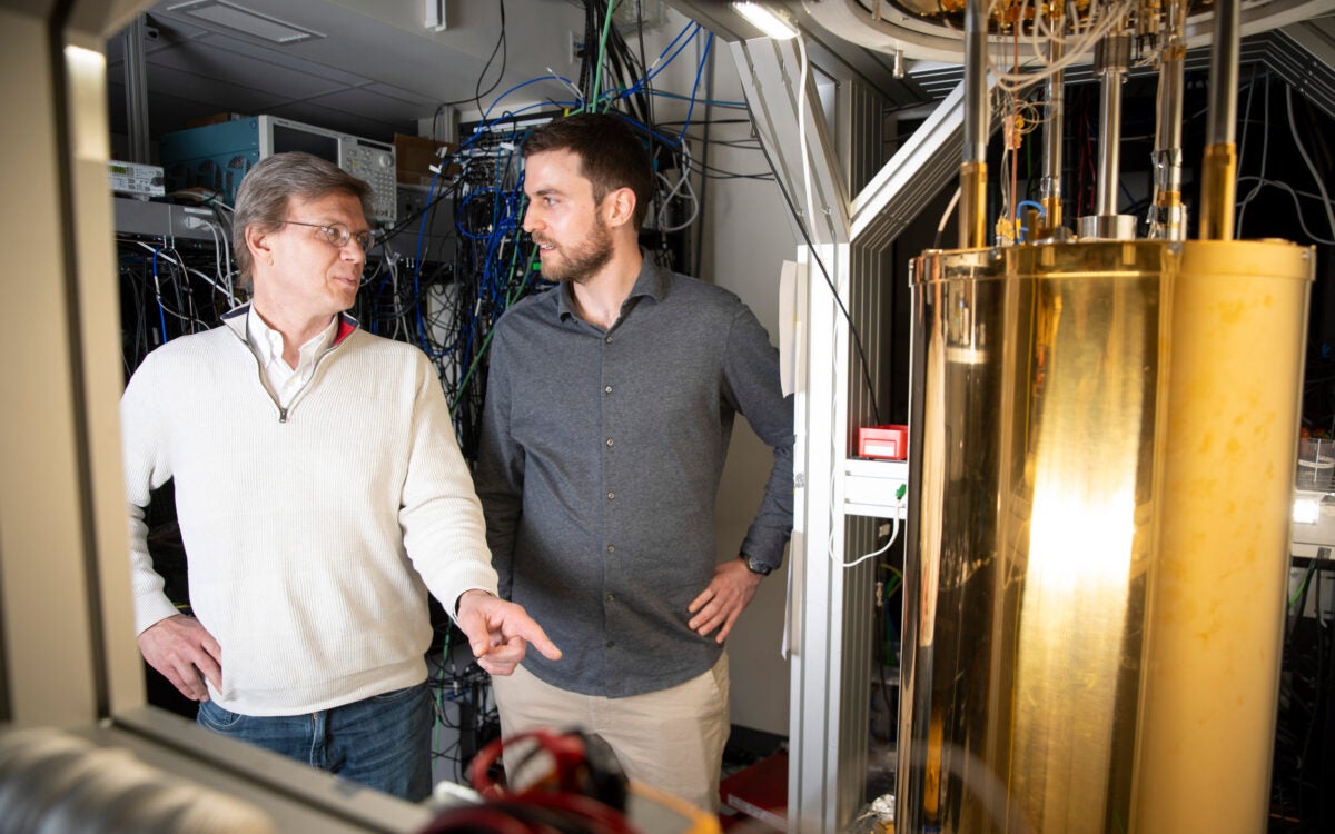 Mikhail Lukin (left) and Can Knaut stand near a quantum network node.