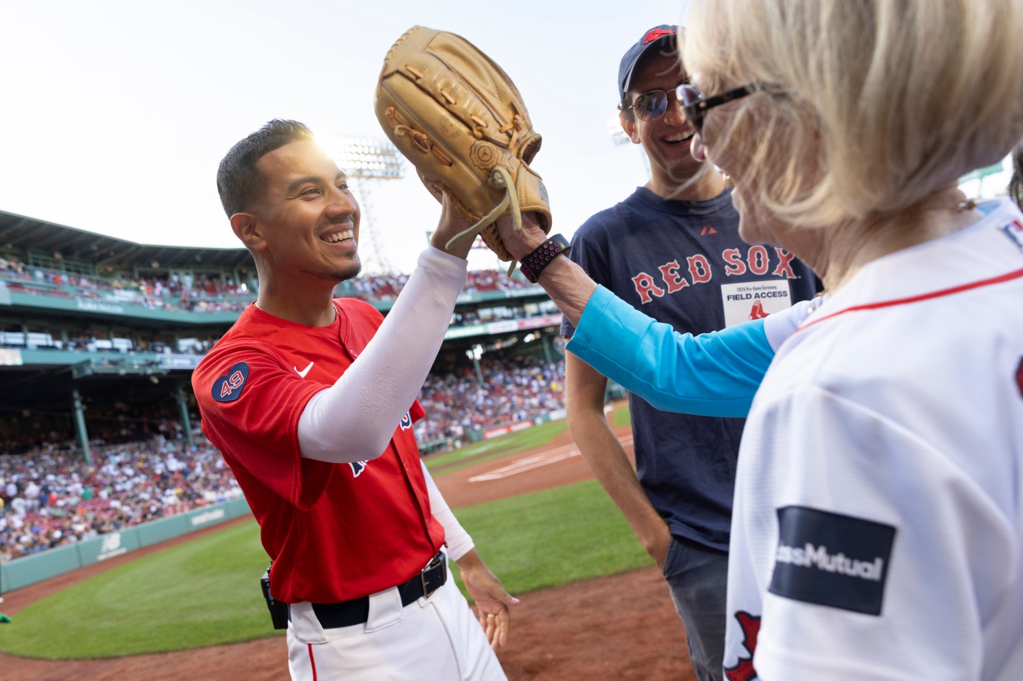 Claudia Goldin (right) interacts with a member of the Red Sox staff. 