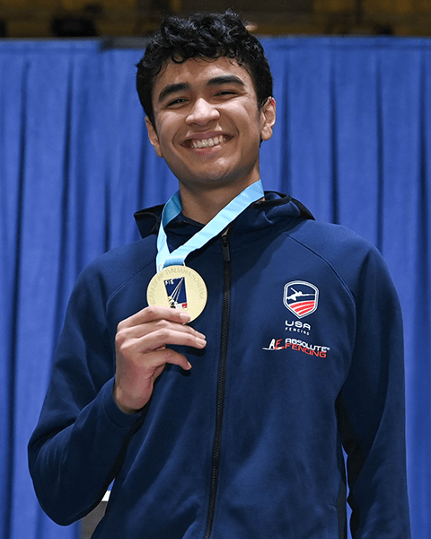 Colin Heathcock holding a medal.