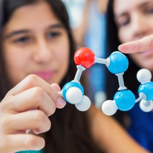 Mother teaching daughter about molecules.