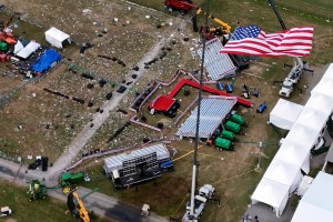 American flag flies in foreground of aerial view of Trump rally site days after attempted assassination.