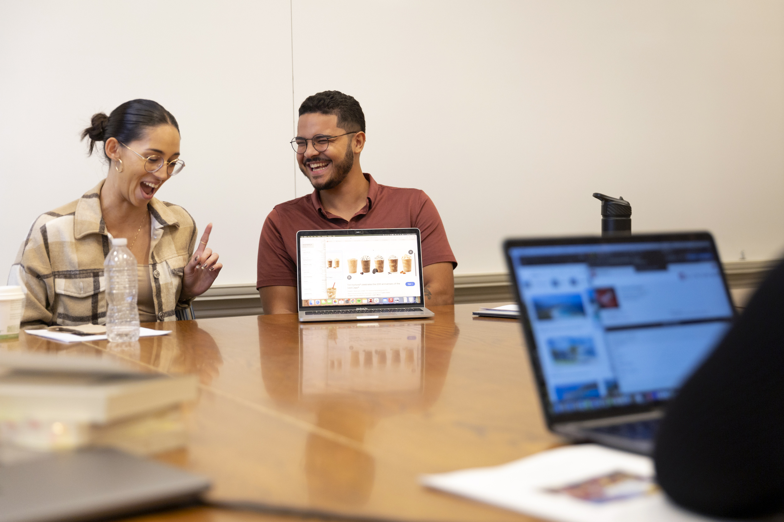 Ayah Khan '25 (left) and Adrian Munoz '25 laughing during class in the Barker Center.