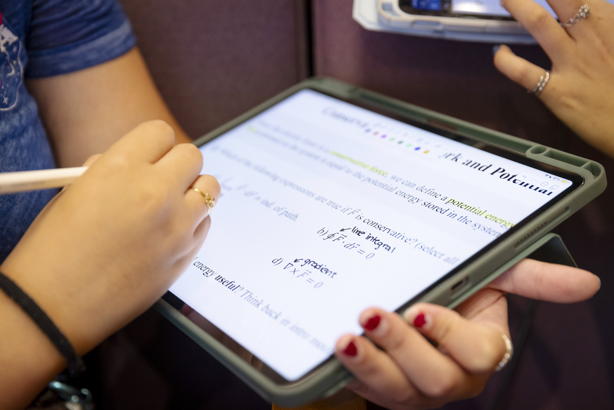 A student works on an iPad during a physics class taught in the Science Center Hall A.