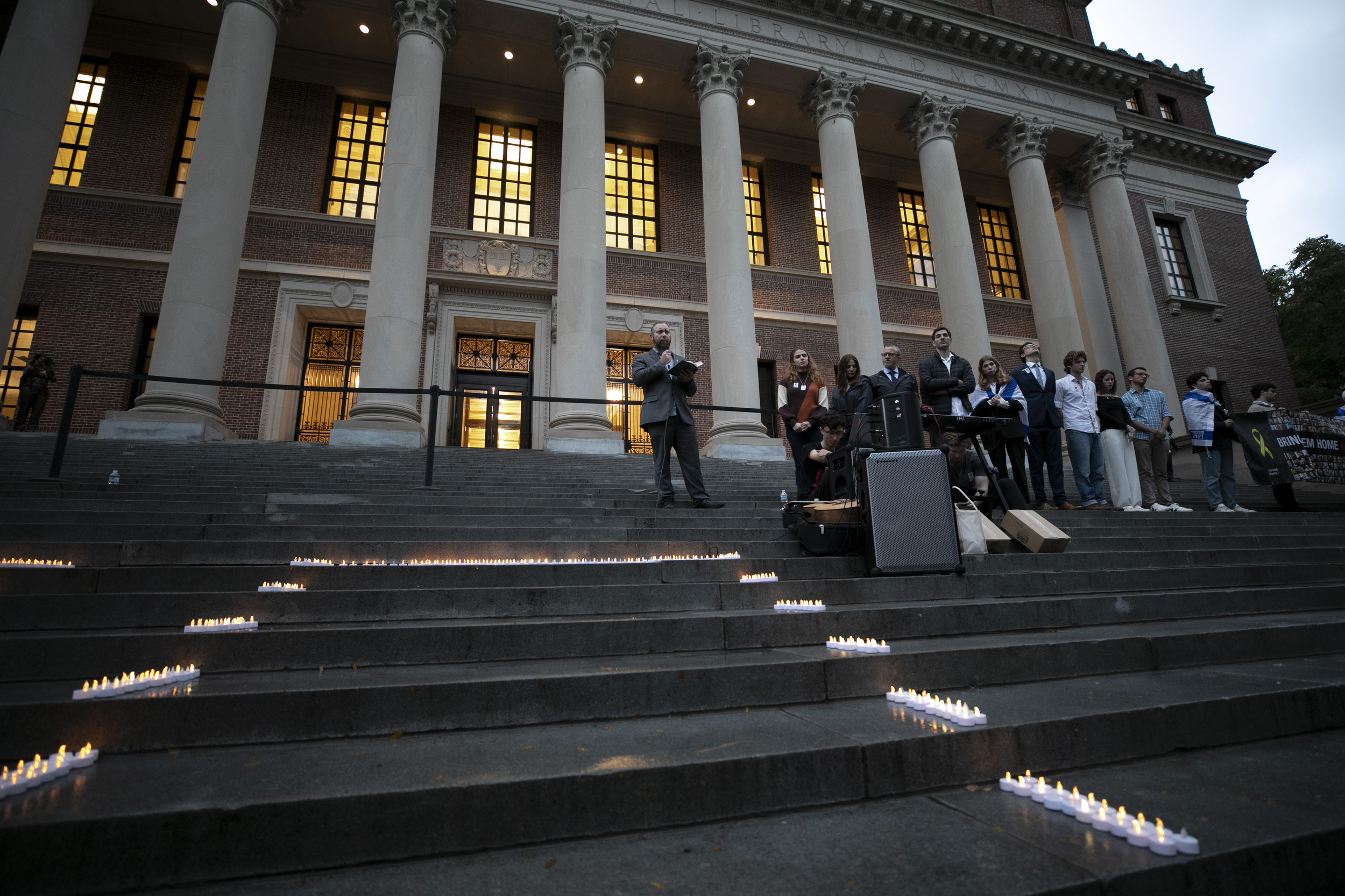 Rabbi Getzel Davis speaks during a vigil on the steps of Widener.