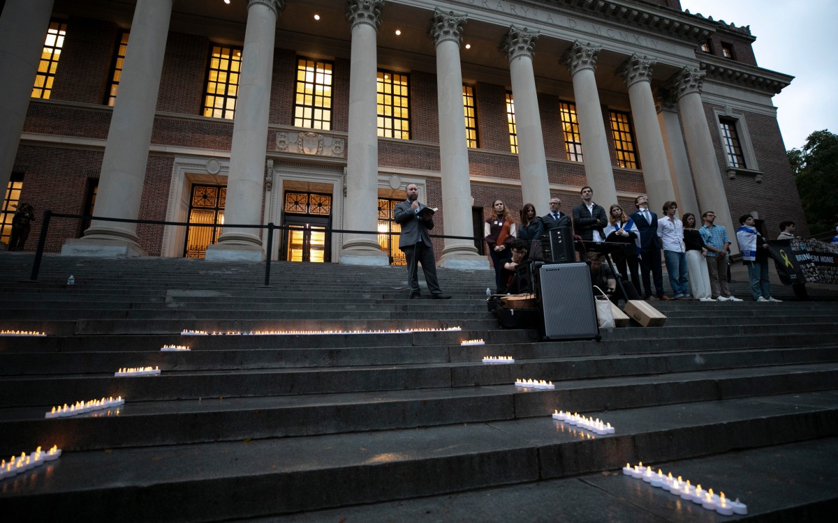 Rabbi Getzel Davis speaks during a vigil on the steps of Widener.