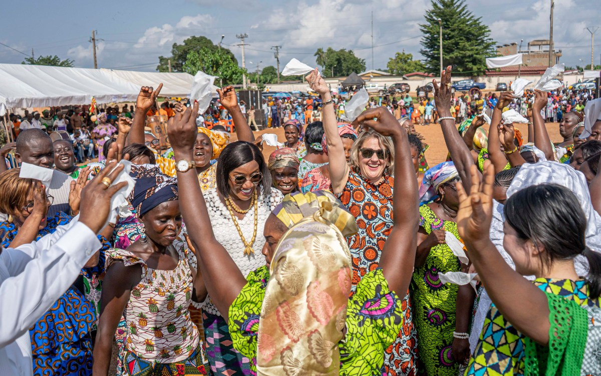 Mara Bolis (center) dances at a June event celebrating the mothers of La Mé, Côte d'Ivoire with Mayor Florence Achi (left) and HKS student Kotomi Odate (far right).