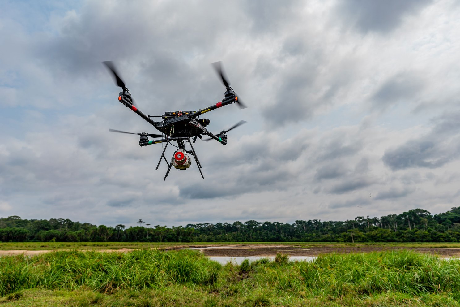 Drones equipped with Lidar flying over bais.