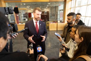 Andrew Aurich (pictured) answers questions from the media. Photos