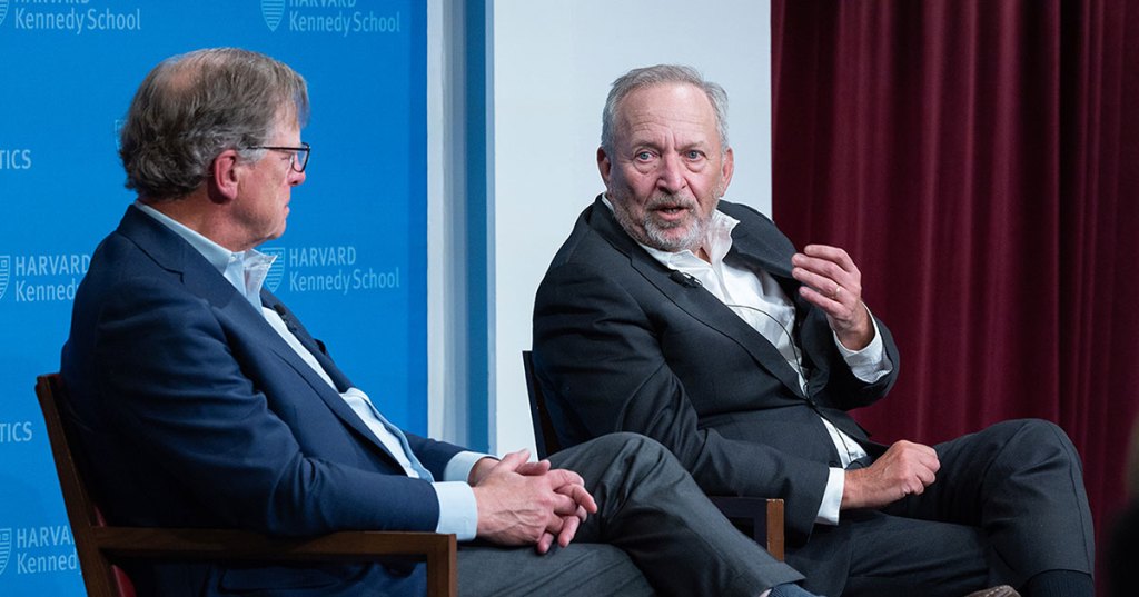 Journalist John Ellis and Lawrence Summers.