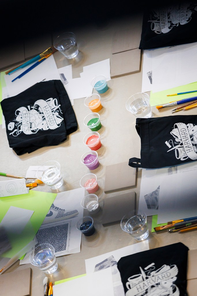 Underglaze materials line the table for a tile making session at the Harvard Ceramic Center.