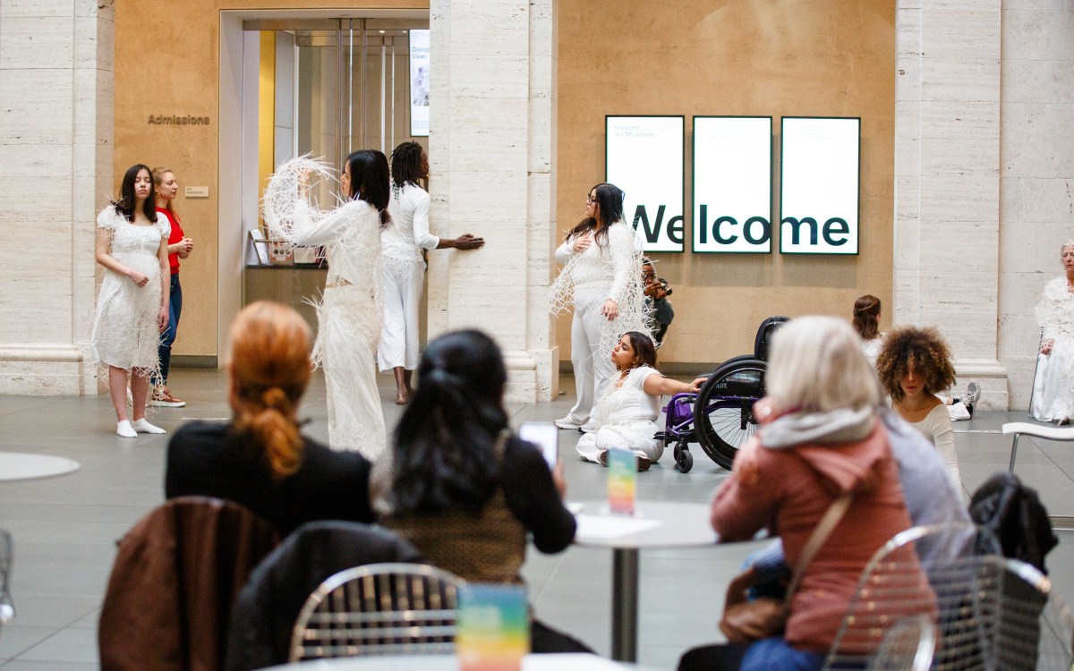 Audience members observe ON DISPLAY HARVARD, performed in the Calderwood Courtyard at the Harvard Art Museums.