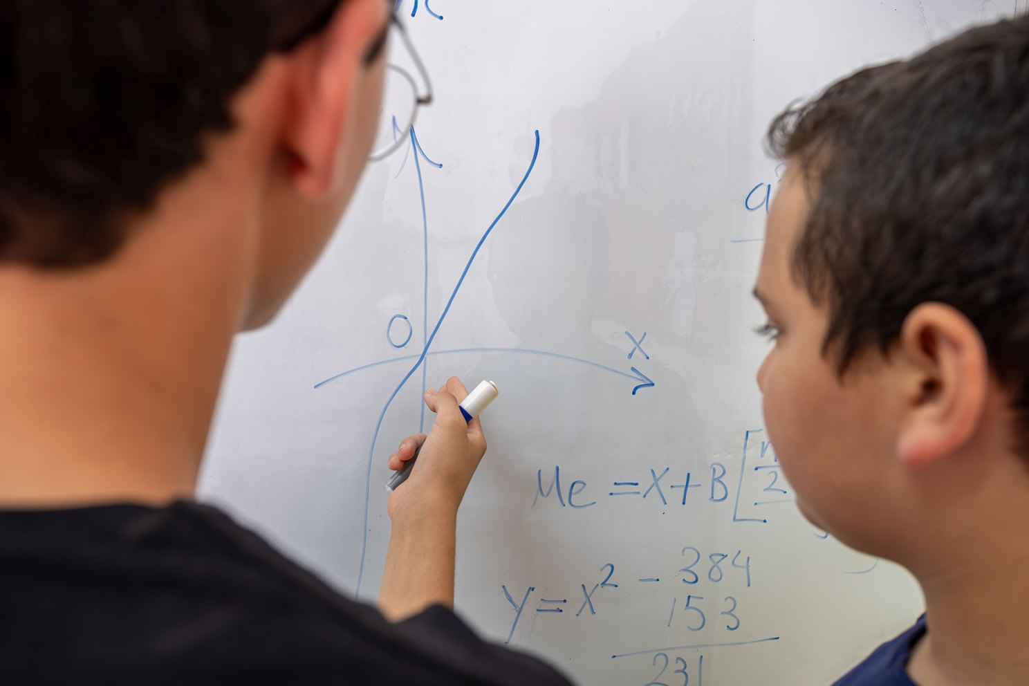 Two students working on a math problem.
