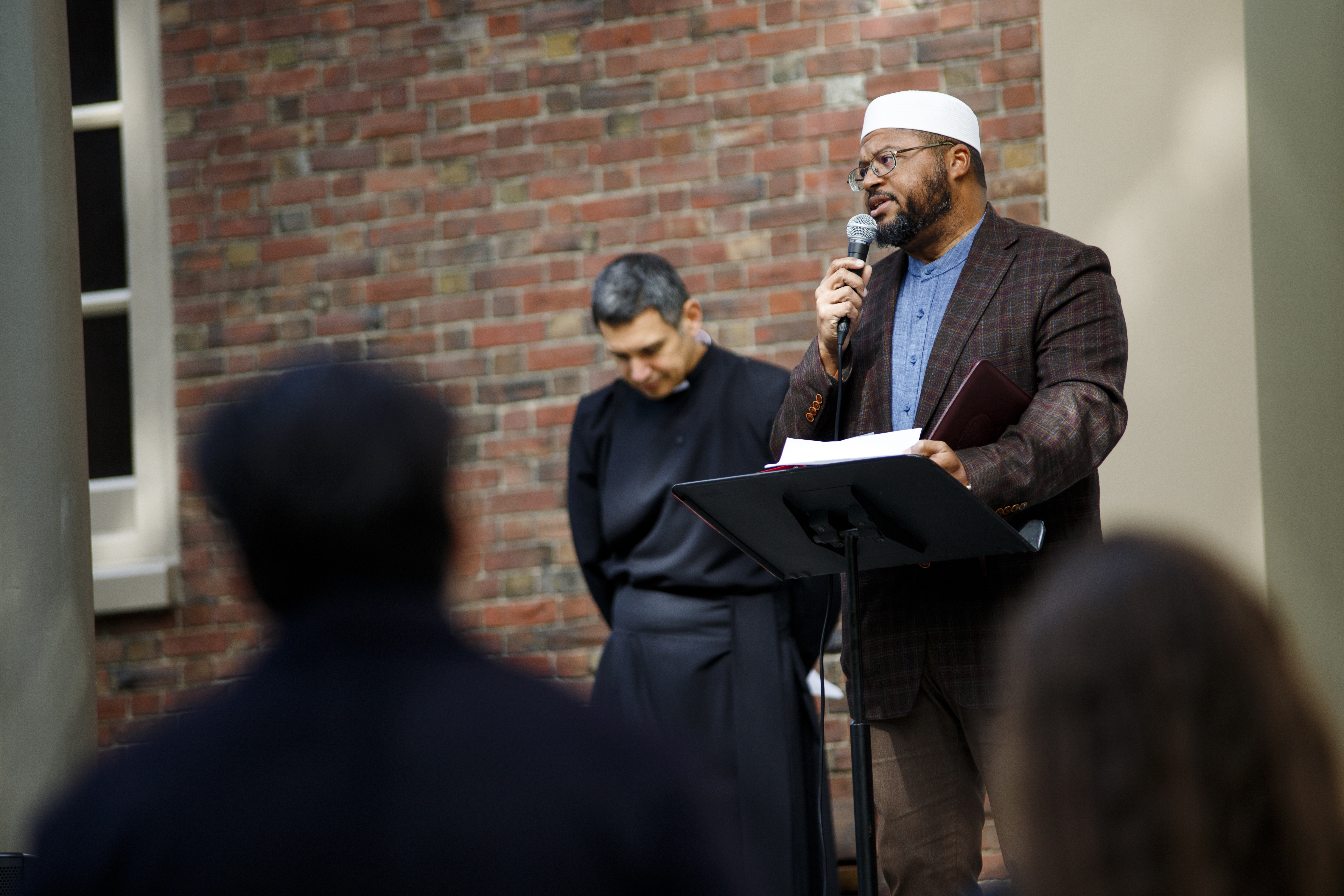 Imam Dr. Khalil Abdur-Rashid speaks at an interfaith vigil outside Harvard's Memorial Church.