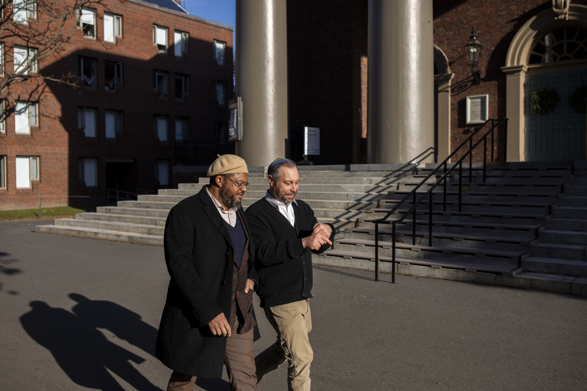 Imam Khalil Abdur-Rashid and Rabbi Getzel Davis walking on campus.