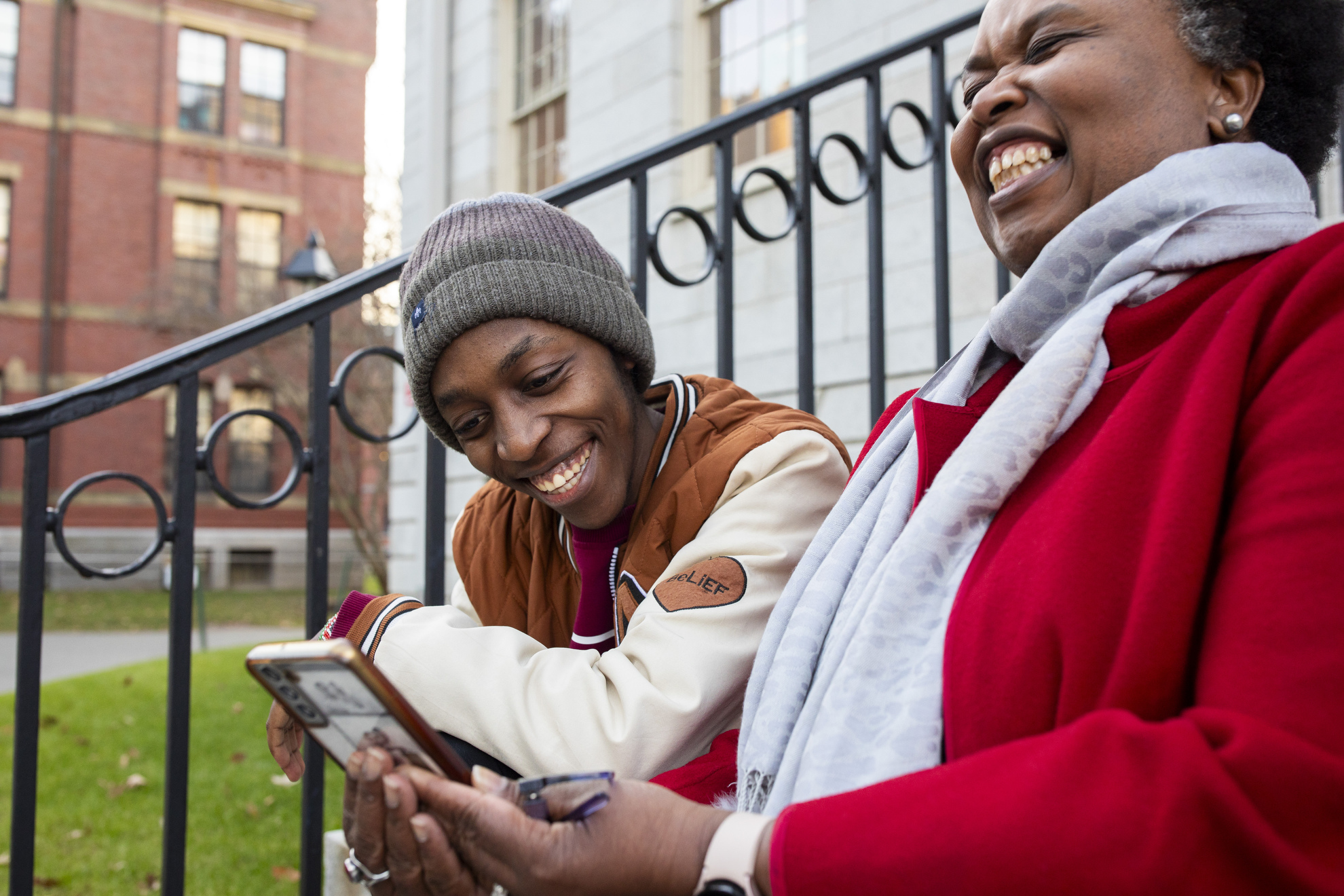 Emmanuel Enan Gachogu Muriuki (left), a first-year, and Sheila Thimba share a joke while looking at a phone 