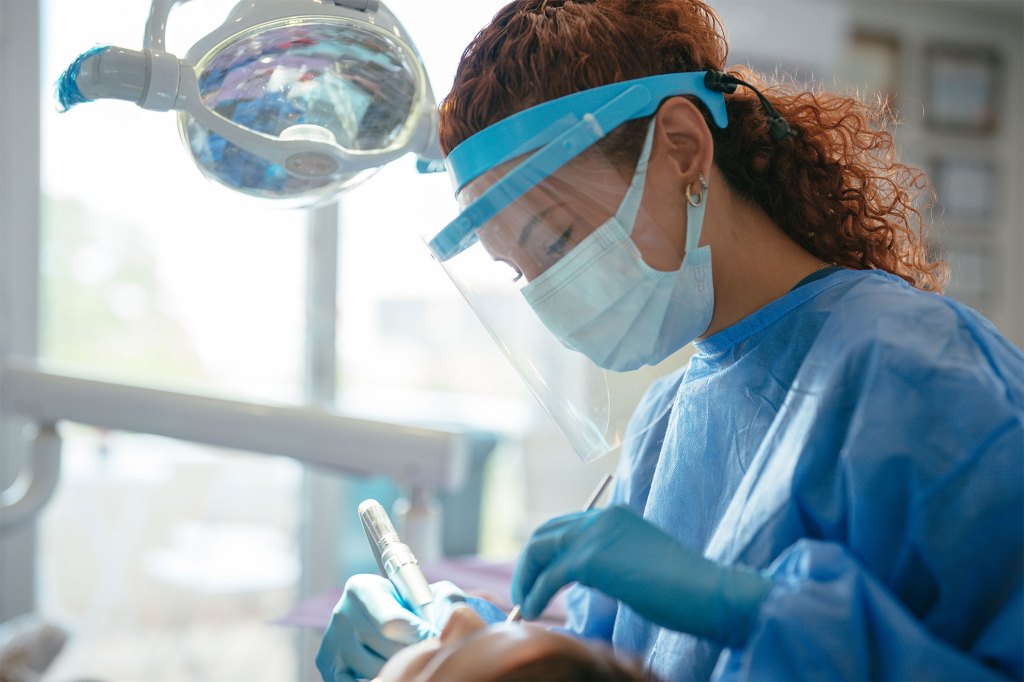 Dentist examining patient's teeth.