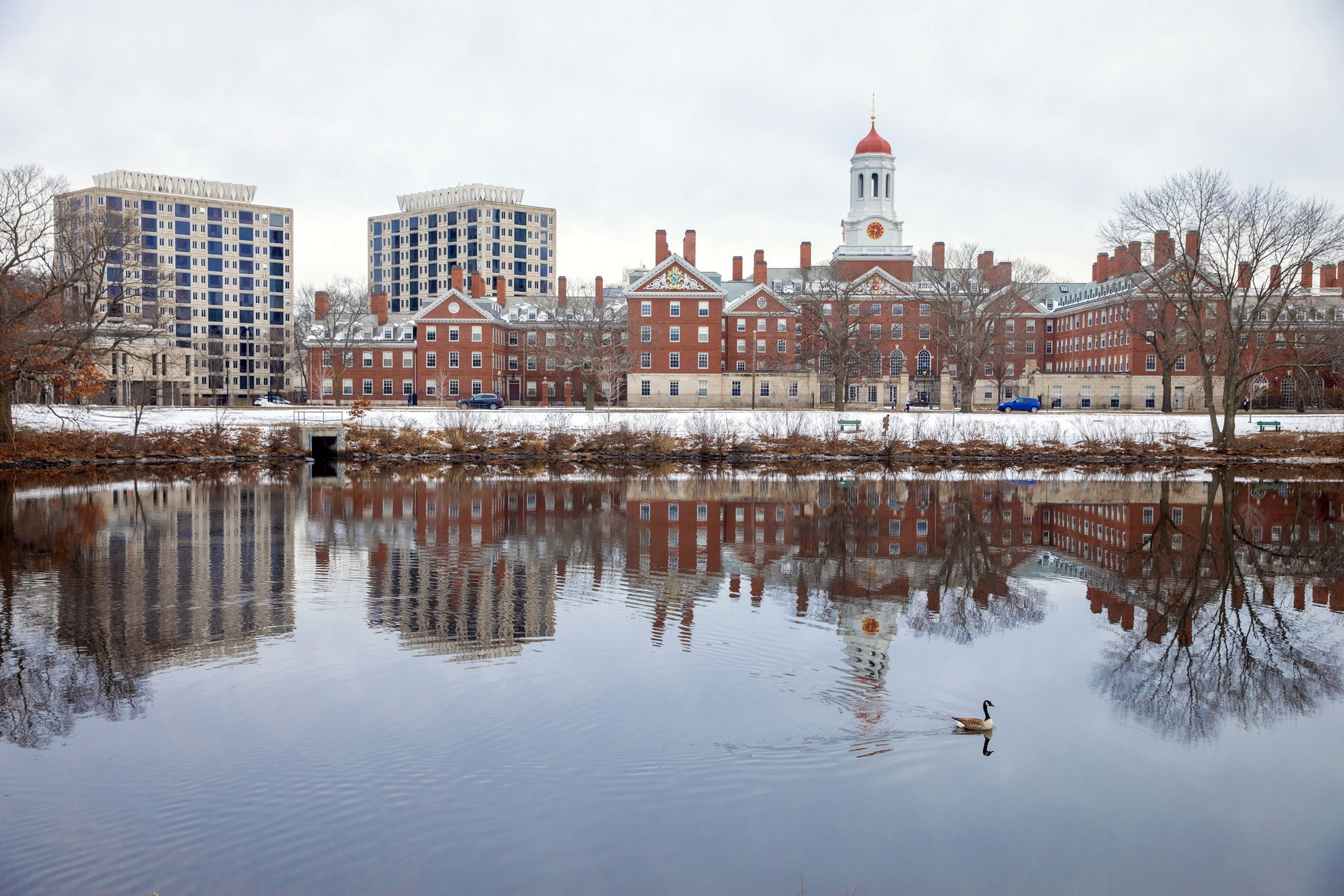 Dunster House reflects onto a placid Charles River.