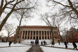 Students walk past Widener Library on their way to class through the freshly fallen snow.