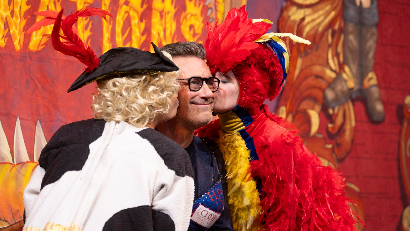 Ava Pallotta and Jessica Zisk kiss Hasty Pudding Man of the Year Jon Hamm during his roast in Farkas Hall.