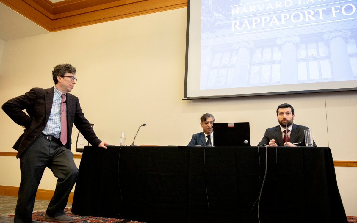 Alan Rozenshtein (right) Jonathan Zittrain (standing), and nupam Chander, a professor of law.